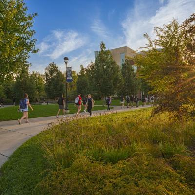 students walking through the Stowe Gateway and Garfield Ave mall on a fall day